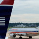 An American Airlines plane and a US Airways plane are parked at Ronald Reagan National Airport in Washington