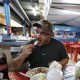 Michael Beverly, of Newfoundland, Canada, samples a grilled octopus taco at the restaurant El Mazateno, in Tijuana, Mexico