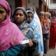 Women stand in a line to cast their vote at a polling centre during parliamentary elections in Dhaka