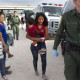 Some of a dozen women and children from Honduras are apprehended by Border Patrol near the Anzalduas International Bridge not far from the border with Mexico at the Rio Grande river in Mission, Tex