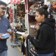 Tony Bernabe gives information to Daisy Juarez in downtown Los Angeles advertising a massive information session to tell immigrants more about President Barack Obama’s executive actions on immigration.