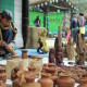 Mangal Singh from Uttarakhand chisels pine barks into an artpiece at Surajkund Mela