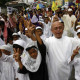 A Catholic priest s joined by Muslim children during a peace march of the Muslim community in Taguig city