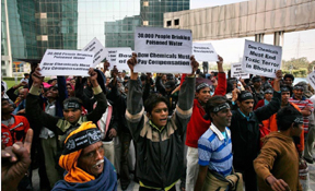 File photo of activists and survivors of the 1984 Bhopal gas leak disaster that killed and harmed thousands hold placard again Dow Chemical Company outside it's office in Noida, on the outskirts of New Delhi, India, November 19, 2009
