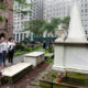 Visitors at the cemetery of Trinity Church photograph the grave of Alexander Hamilton, in New York's Financial District. Interest in historic sites associated with Hamilton has increased thanks to the hit Broadway musical “Hamilton.”