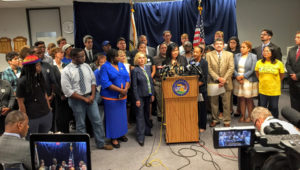 Kathleen Yang-Clayton of Asian Americans Advancing Justice addressing the gathering opposed to Governor's veto