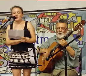 Sergio playing guitar with Daria singing