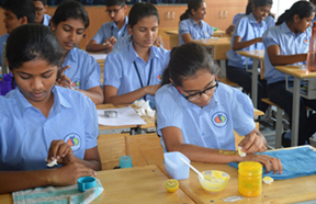 Students making and trying out face packs made with kitchen ingredients