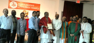 Sri. Tanikella Bharani being presented with a Plaque by Dr Thotukara and a group of organizers