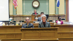 Representative Janak Joshi, left, introduces the resolution to honor Mahatma Gandhi and his work with Representative Joann Ginal looking on