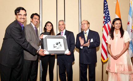Chicago Mayor Rahm Emanuel being presented with a portrait of Mahatma Gandhi with a Gandhian inscription