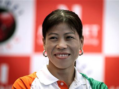 FILE - In this July 22, 2012 file photo, Indian boxer M.C. Mary Kom smiles during a press conference in New Delhi, India. India's star woman boxer M.C. Mary Kom is not surprised at the crowd support for her at the Asian Games. The sprightly 31-year-old acknowledges cheers from the stands and does not even mind being pushed around as her fans jostle with each other to get pictured with her. (AP Photo/Saurabh Das, File)
