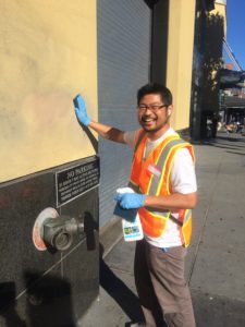 Patrick Swen of Lassen Tours cleaning up graffiti at Fisherman's Wharf